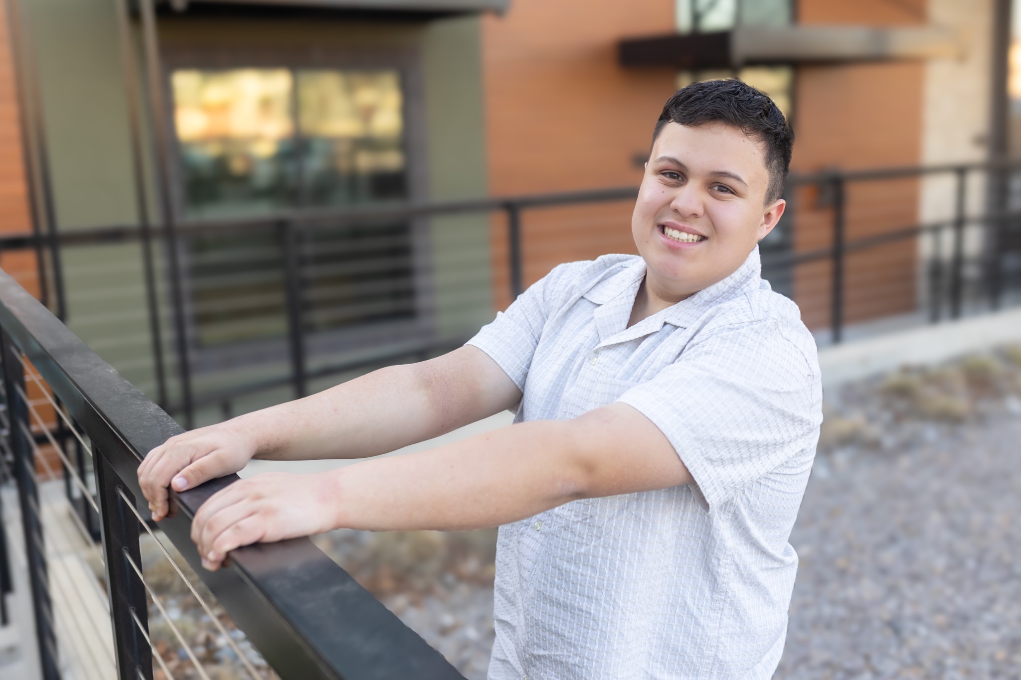 Andy Roberts smiling and leaning on an outdoor railing